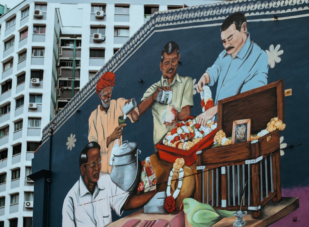 graffiti singapore four man eating and drinking wall painting near tall building at daytime